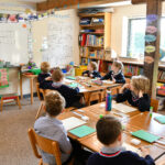 Classroom with clearly defined separate spaces for different year groups, illustrating the concept of separate classrooms in primary education.